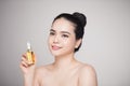 Beauty concept. Asian pretty woman with perfect skin holding oil Royalty Free Stock Photo