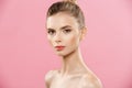 Beauty Concept - Beautiful Woman with Clean Fresh Skin close up on pink studio. Skin care face. Cosmetology. Royalty Free Stock Photo