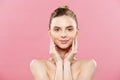 Beauty Concept - Beautiful Woman with Clean Fresh Skin close up on pink studio. Skin care face. Cosmetology. Royalty Free Stock Photo