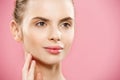 Beauty Concept - Beautiful Woman with Clean Fresh Skin close up on pink studio. Skin care face. Cosmetology. Royalty Free Stock Photo