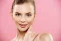 Beauty Concept - Beautiful Woman with Clean Fresh Skin close up on pink studio. Skin care face. Cosmetology. Royalty Free Stock Photo