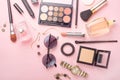 Beauty concept in a blog. Professional female make-up accessories: watch, bracelet, lipstick, powder, on a pink background. Women