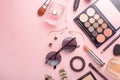 Beauty concept in a blog. Professional female make-up accessories, watch, bracelet, lipstick, powder, on a pink background. Women