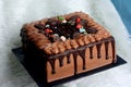 Beauty concept. blur square chocolate cake with fur fabric table cloth
