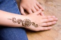 henna tattoo on small girl hand. Mehndi is traditional Indian decorative art. Close-up, overhead view - beauty concept Royalty Free Stock Photo