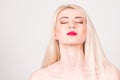 Beauty concept. Portrait of a woman with blond hair, red lips, visage and eyes closed Royalty Free Stock Photo