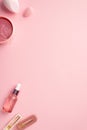 Beauty concept. Top view vertical photo of beauty blenders pink eye patches with special spoon pink transparent dropper bottle and Royalty Free Stock Photo