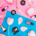 Beauty concept with tulips flowers and cosmetics on blue and pink background. Top view. Flat lay. Spring time Royalty Free Stock Photo