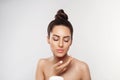 Beauty Concept. Woman Applying  Cosmetics Cream and Smiling. Female holds a bottle cream in her hand and spreads it on her face  t Royalty Free Stock Photo