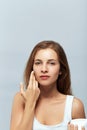 Beauty Concept. woman holds a moisturizer in her hand and spreads it on her face  to moisturize her skin and wrinkle from impuriti Royalty Free Stock Photo