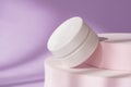 Beauty cosmetic cream jar mockup on purple podium pedestal showcase. White package creme container on pedestal with