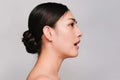 Beauty and Cosmetics Concept-Side face of Youthful pretty young Asian woman on gray background