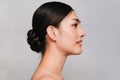 Beauty and Cosmetics Concept-Side face of Youthful pretty young Asian woman on gray background