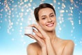 Happy young woman holding jar of cream Royalty Free Stock Photo