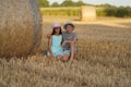 Beauty Couple relaxing on wheat field together. Teenage girlfriend and boyfriend having fun outdoors, kissing and Royalty Free Stock Photo