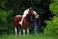 Beauty cowgirl with appaloosa horse