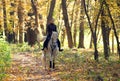 Beauty cowgirl riding painted horse down the path in the evening Royalty Free Stock Photo