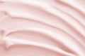 Beauty cream texture background. Pink color cosmetic cream lotion moisturizer smear