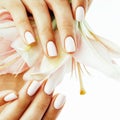 Beauty delicate hands with manicure holding flower lily close up Royalty Free Stock Photo