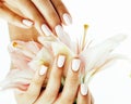 Beauty delicate hands with manicure holding flower lily close up isolated on white Royalty Free Stock Photo
