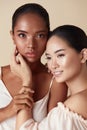 Beauty. Diversity Models Portrait. Asian And Mixed Race Women Standing Together And Bonding Hands Against Beige Background.