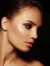 Beauty elegant portrait of a appealing naked brunette with full lips and smoky eyes make up on the black background Royalty Free Stock Photo