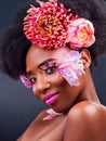 Beauty, eyelashes and flowers with portrait of black woman in studio on dark background for natural makeup. Afro Royalty Free Stock Photo