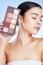 Beauty, eyeshadow and woman with makeup on blue background for cosmetics, powder and foundation. Cosmetology, salon