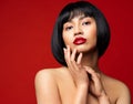 Beauty Face. Fashion Model with Red Lipstick Make up and Black Bob Haircut. Asian Woman with Perfect Skin and Nails Manicure Royalty Free Stock Photo