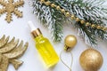 Beauty face oil in glass dropper bottle on festive new year background with golden sparkling toys and fir branch. Frstive skin Royalty Free Stock Photo