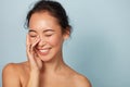 Beauty face. Smiling asian woman touching healthy skin portrait Royalty Free Stock Photo