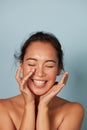 Beauty face. Smiling asian woman touching healthy skin portrait Royalty Free Stock Photo