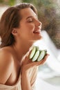 Beauty Face. Woman Holding Slices Of Fresh Juicy Aloe Vera Leaf. Tender Brunette With Naked Shoulder And Natural Makeup. Royalty Free Stock Photo