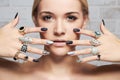 Beauty face.woman`s hands with jewelry rings