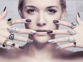 Beauty face.woman`s hands with jewelry rings