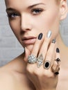 Beauty face.woman& x27;s hands with jewelry rings