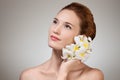 Beauty face of young beautiful woman with flower. Royalty Free Stock Photo