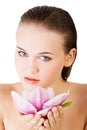 Beauty face of the young beautiful woman with flower. Royalty Free Stock Photo