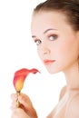 Beauty face of the young beautiful woman with flower. Royalty Free Stock Photo
