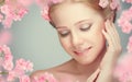 Beauty face of young beautiful woman with pink flowers Royalty Free Stock Photo