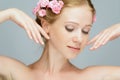 Beauty face of young beautiful woman with pink flowers Royalty Free Stock Photo