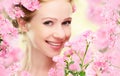 Beauty face of young beautiful woman with pink flowers Royalty Free Stock Photo