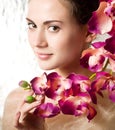 Beauty face of the young woman with flower Royalty Free Stock Photo