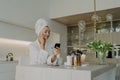 Happy healthy woman in bathrobe doing skincare daily routine after taking shower or bath at home Royalty Free Stock Photo