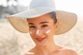 Beauty Facial Care. Young  Female Holding Bottle Sun Cream and  Applying on Face Smiling. Beauty Face. Royalty Free Stock Photo