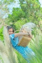 Beauty Farm lady carrying a basket walking in agricultural field for carefree and healthy nature lifestyle concept