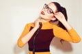 Beauty Fashion brunette model girl wearing stylish glasses. woman with perfect makeup, trendy orange and red dress Royalty Free Stock Photo