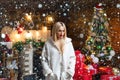 Woman in snow. Beauty fashion girl with Christmas present box. Girl is happy about the new year. Woman in evening dress Royalty Free Stock Photo