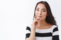 Beauty, fashion and healthcare concept. Tender, feminine young asian woman with clean skin, touching cheek and jawline Royalty Free Stock Photo