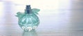 Beauty/fashion Image of elegant perfume bottle over pastel background. vintage filtered image